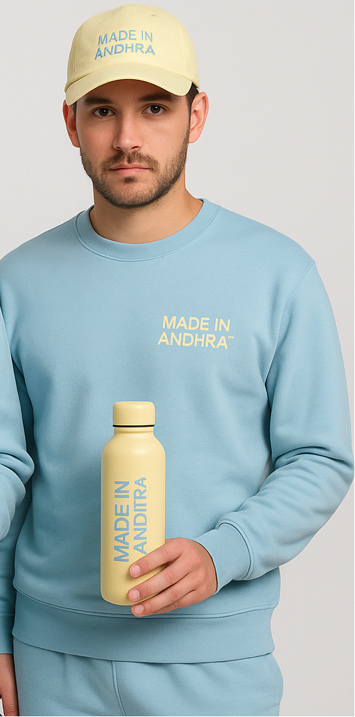 Two people wearing matching light blue outfits with 'MADE IN ANDhra' text, holding a yellow bottle.